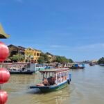 River scene in Hoi An with traditional boats and historic buildings