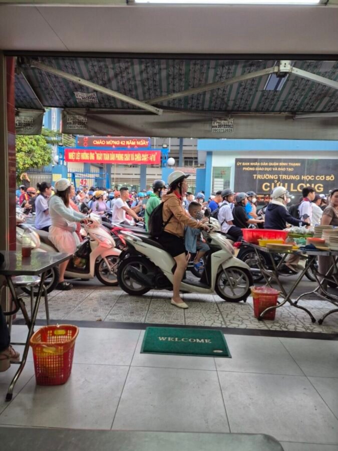HCMC busy street Motorbikes and pedestrians crowding a busy street in Ho Chi Minh City