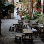 Quiet outdoor cafe in Chiang Mai with natural light and minimal visual distraction, conveying pause and reduced sensory demand.