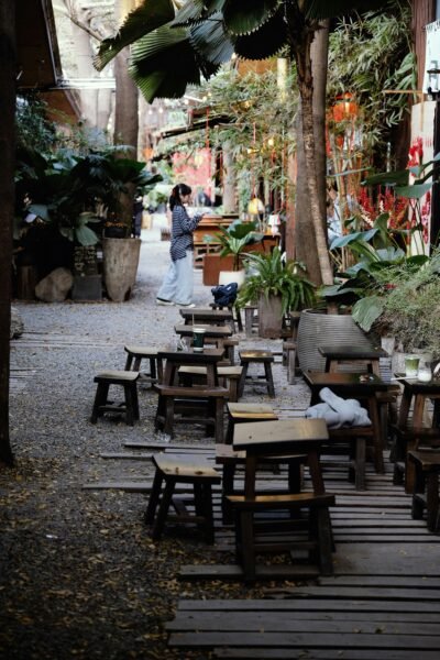 Quiet outdoor cafe in Chiang Mai with natural light and minimal visual distraction, conveying pause and reduced sensory demand.