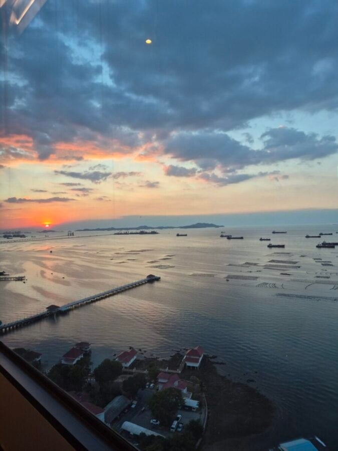 Quiet coastal scene in Thailand at golden hour with calm light and open space