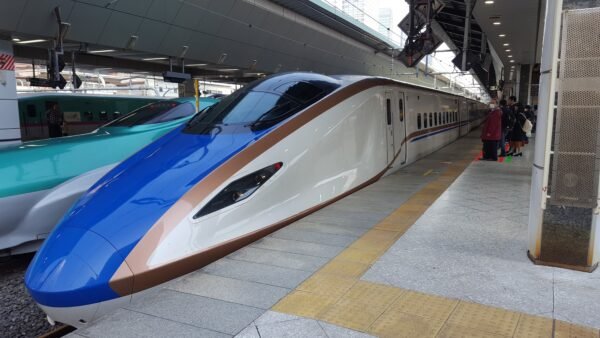 Tokyo train station signage showing rail lines and directions