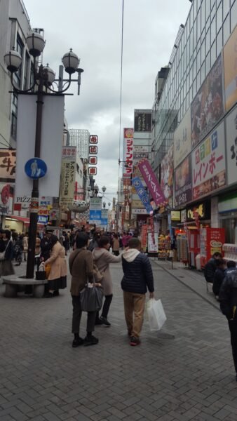 Street scene in central Osaka with pedestrians and shops