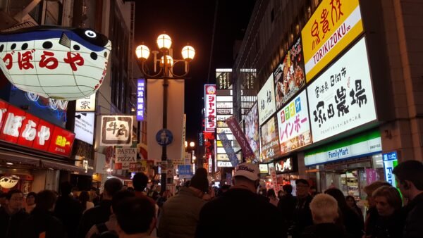Evening street scene in Osaka with people walking