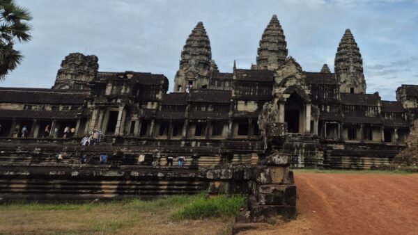 Angkor Wat main temple entrance in Siem Reap with stone towers, steps, and visitors exploring the complex