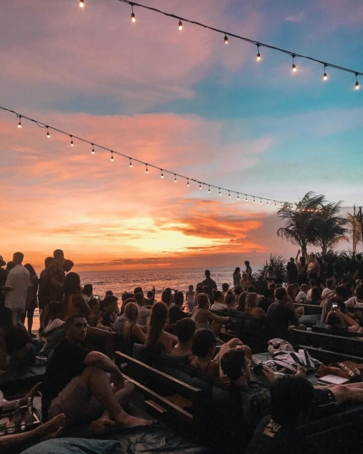 bali-beach-club-sunset-crowd-seminyak-canggu Crowd at a beach club during sunset in Bali showing busy social atmosphere