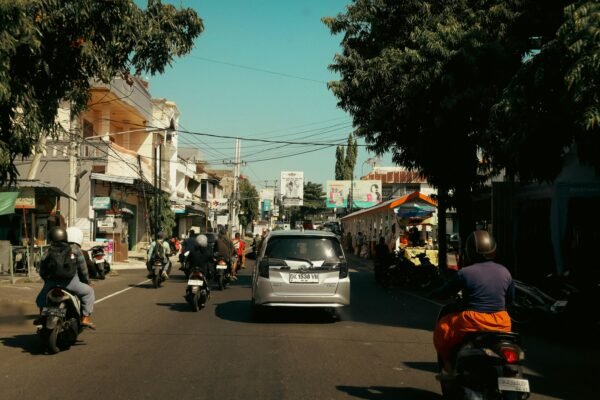 Traffic in Bali with scooters and cars sharing the road in a busy street