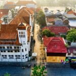 Aerial view of Jakarta Kota Tua old town with colonial buildings and red tiled rooftops along a narrow street