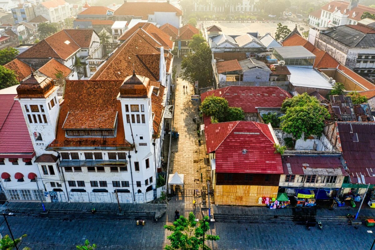 Aerial view of Jakarta Kota Tua old town with colonial buildings and red tiled rooftops along a narrow street