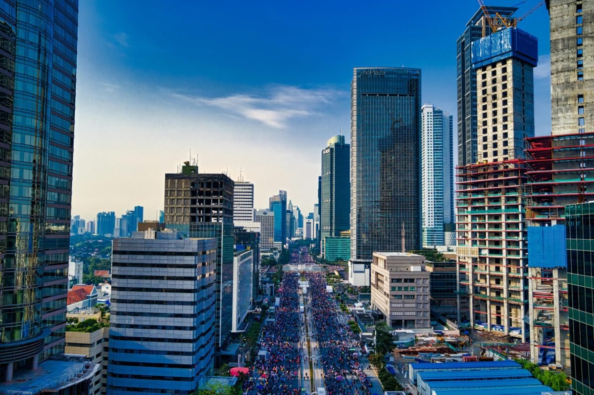 jakarta-sudirman-skyline-car-free-day Jakarta skyline along Sudirman road with crowds during car free day surrounded by high rise buildings and construction sites