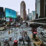 Busy Bukit Bintang intersection in Kuala Lumpur with pedestrians, traffic, and elevated monorail track