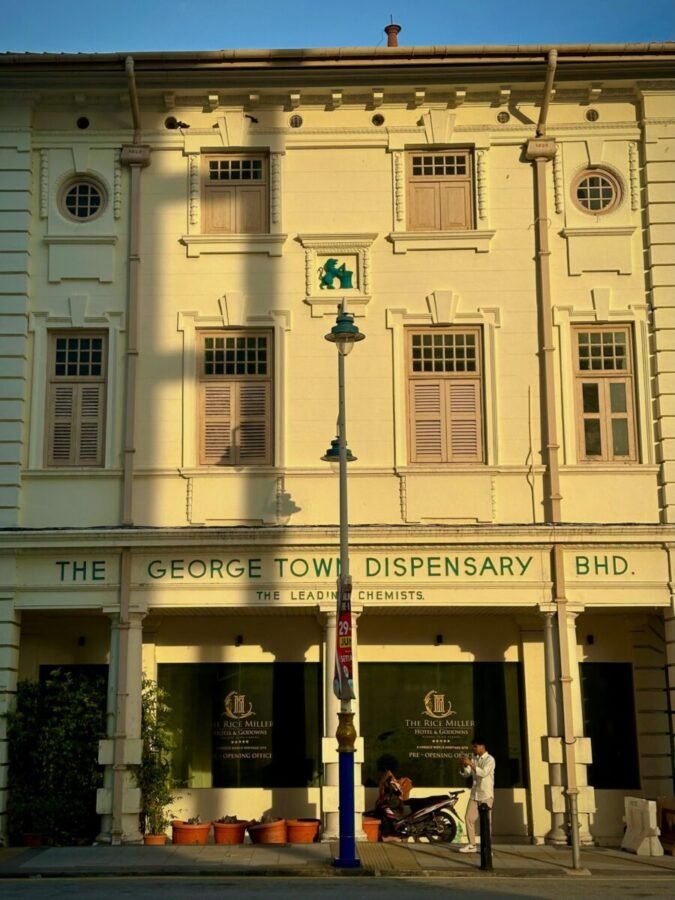 Colonial building in George Town Penang with faded facade and street-level activity
