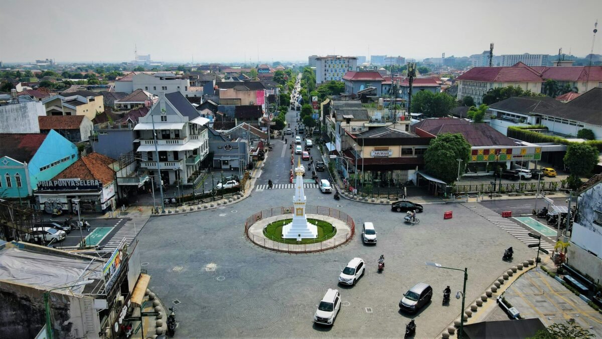 yogyakarta-tugu-roundabout-city-centre-traffic Tugu Yogyakarta roundabout with light traffic and low-rise buildings in central Yogyakarta Indonesia