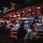 Busy restaurant with bar counter seating where individuals dine separately