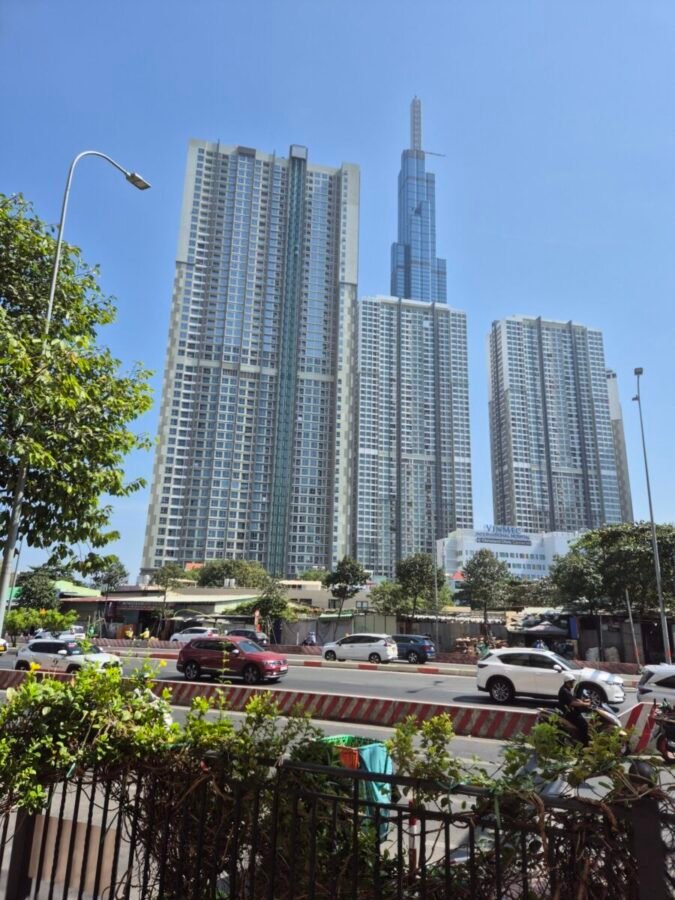 ho-chi-minh-city-skyline-binh-thanh-residential-towers High-rise residential towers in Ho Chi Minh City with street traffic in the foreground, showing contrast between modern buildings and busy roads