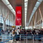 Long check-in queues at Tan Son Nhat Airport in Ho Chi Minh City with travellers waiting at airline counters