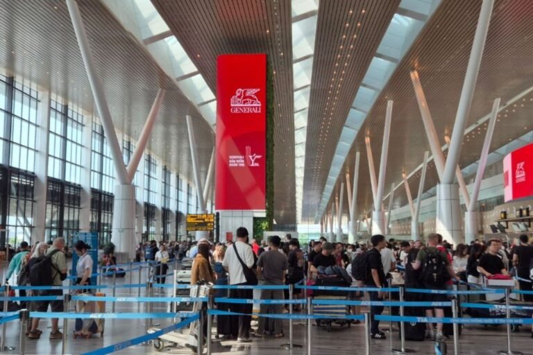 Long check-in queues at Tan Son Nhat Airport in Ho Chi Minh City with travellers waiting at airline counters
