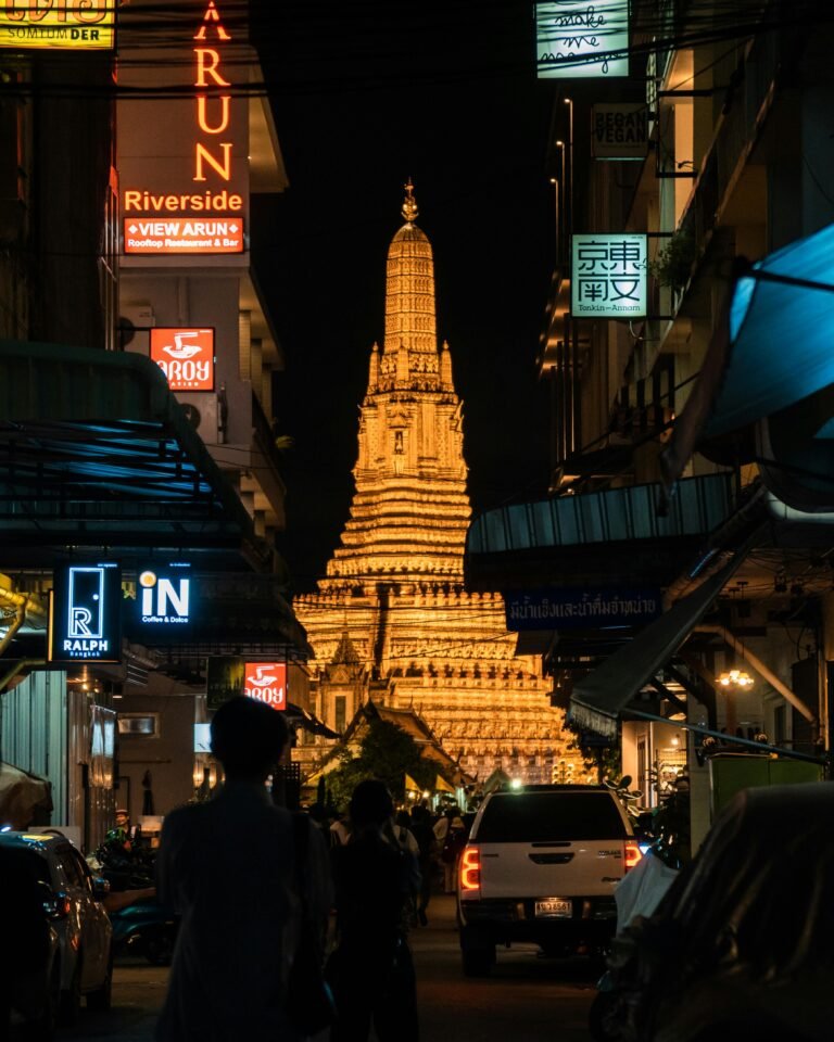 Wat Arun at night from a Bangkok street for first-time visitors