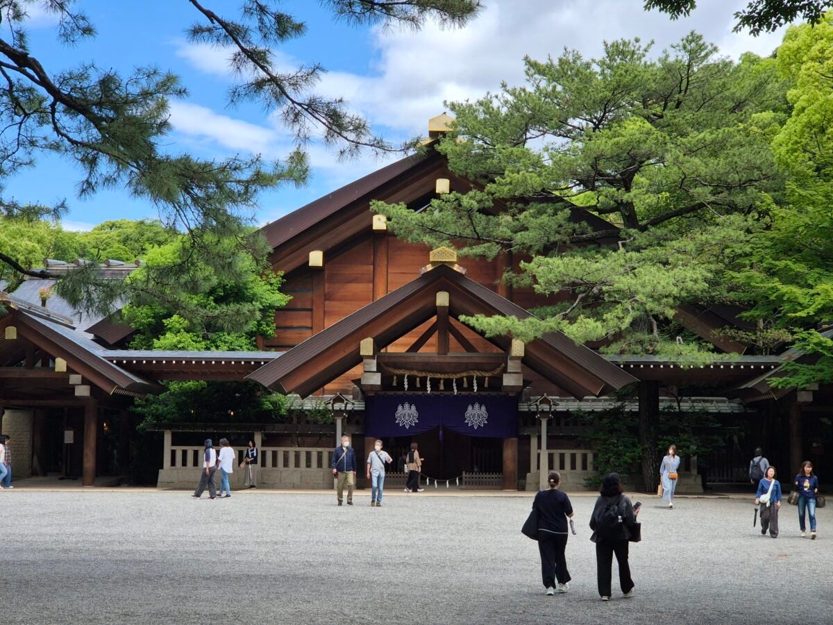 atsuta-shrine-nagoya-main-hall The main hall of Atsuta Shrine in Nagoya, its wooden roof framed by tall trees