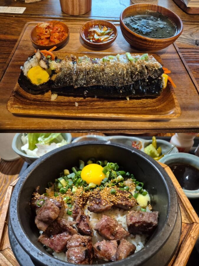 Two Korean dishes recommended for avoiding spice: a large gimbap roll with side banchan, and a sizzling dolsot bibimbap topped with steak, raw egg yolk, and spring onion